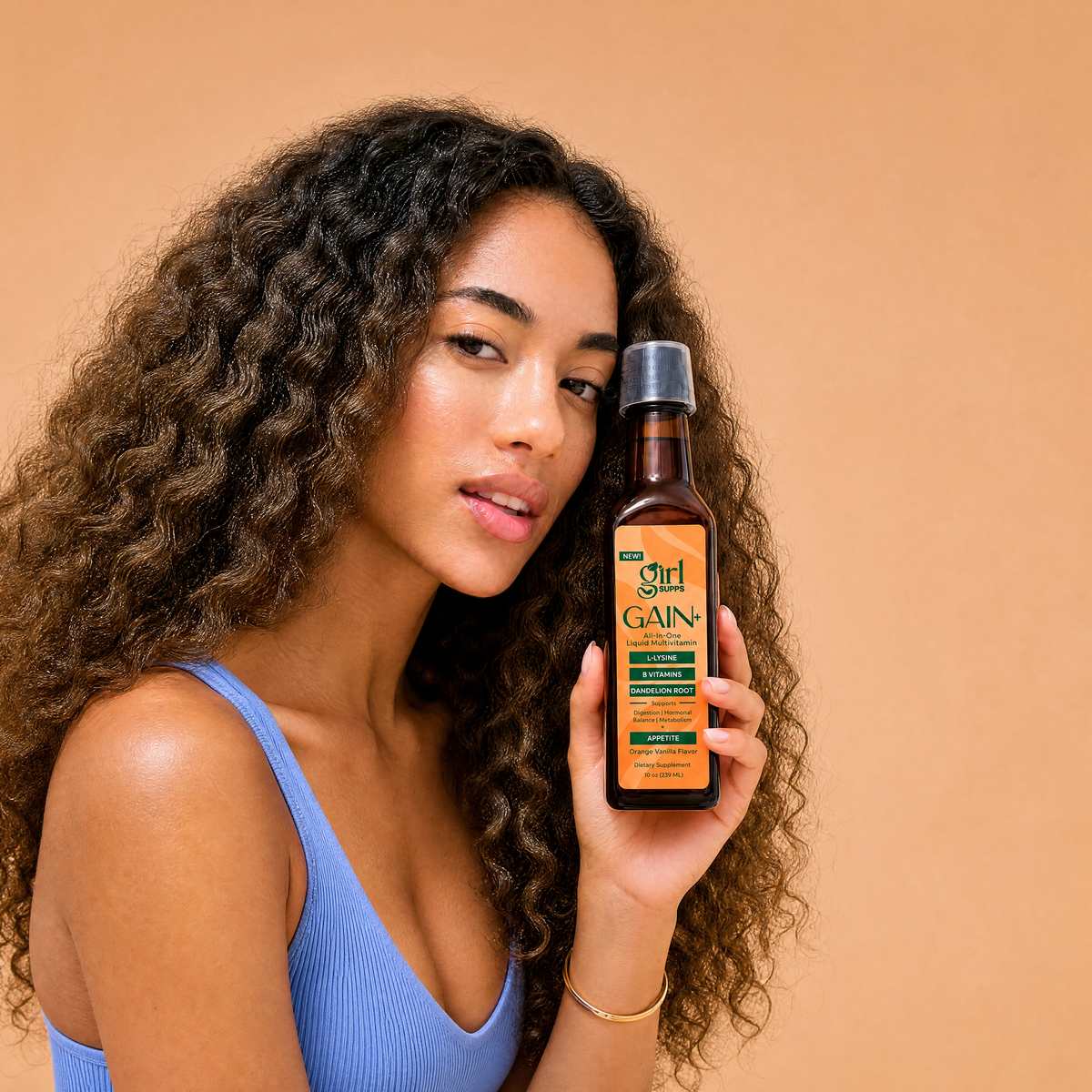 Woman holding bottle of liquid vitamins for her appetite to become stronger