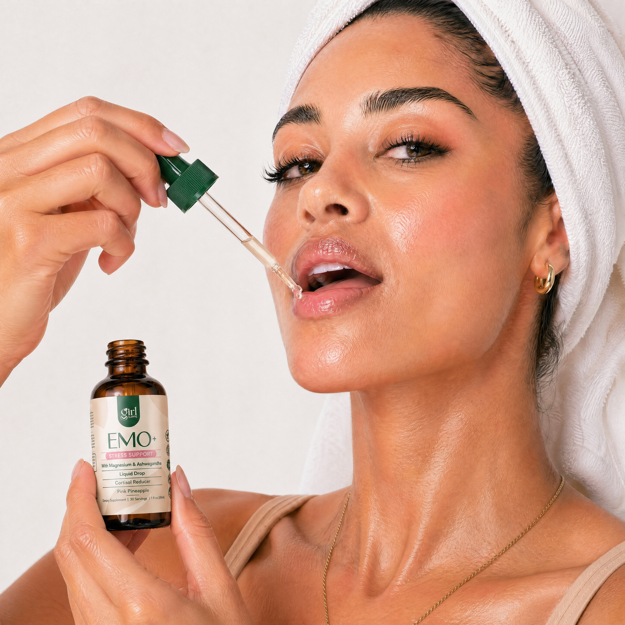 Woman taking a dropper of magnesium product to her mouth to reduce cortisol