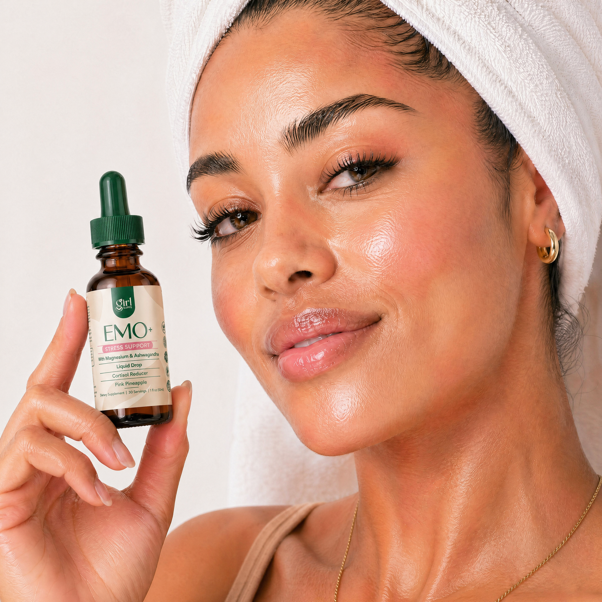 Woman holding a bottle of EMO magnesium drops mood support with a white background